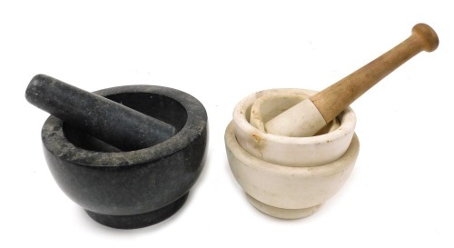 A granite pestle and mortar, together with three stoneware mortars, with pouring lips, and a wooden handled pestle. (6)