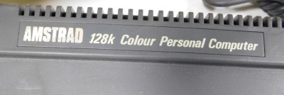 An Amstrad 120k colour personal computer, with disc drive, CPC6128, a monitor, GT65, and a printer, Lo5000di. (3) Buyer Note: WARNING! This lot contains untested or unsafe electrical items. It is supplied for scrap or reconditioning only. TRADE ONLY - 2