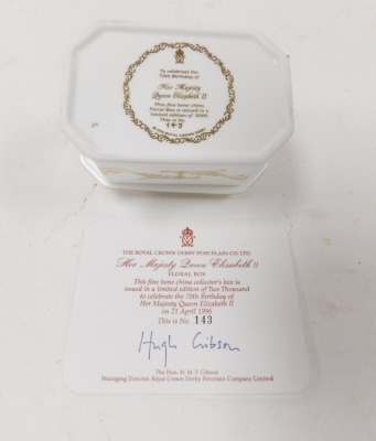 A Royal Crown Derby porcelain floral box, commemorating Her Majesty Queen Elizabeth II's 70th birthday, limited edition 143/2000, with certificate, signed by Hugh Gibson, 11cm wide. - 2