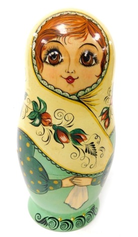 A set of eight graduated Russian Matryoshka nesting dolls, painted to the body with roses, largest doll signed to base, largest doll 17.5cm high.