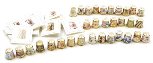 A group of Royal Crown Derby porcelain thimbles, Historical Thimble Collection, with certificates, and further thimbles. (qty)