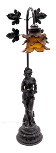 An Art Nouveau style plaster figural table lamp, with a triple layered amber glass floral shade, 69cm high.