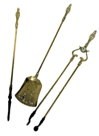 A set of three Victorian brass fire irons, comprising shovel, pair of fire tongs and a poker, 70cm high.