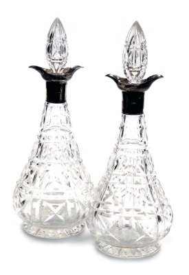 A pair of George V cut glass and silver mounted decanters, and stoppers, London 1926, 32cm high.