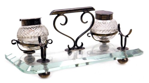 A Victorian silver and cut glass desk stand of oblong form, with two cut glass and silver mounted ink wells, and pen rest, Henry Williamson Ltd, Birmingham 1899, 18.5cm wide.