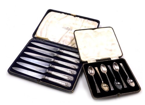 A set of six George V silver coffee spoons, cased, Sheffield 1931, 1.23oz, and a set of six silver handled fruit knives, cased, Sheffield 1925.