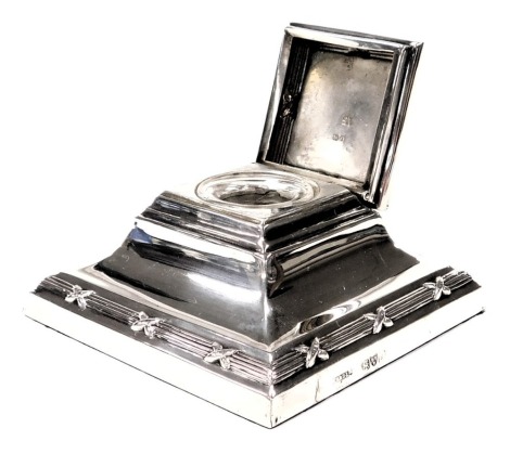 An Edward VII loaded silver inkwell, of outswept square form, with glass liner, Chester 1909, 5.46oz all in.