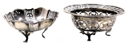 A George V silver sweetmeat dish, with pierced floral and foliate decoration, raised on three hoof feet, Chester 1912, and a further sweet meat dish, raised on three scroll feet, Sheffield 1927, 3.18oz.