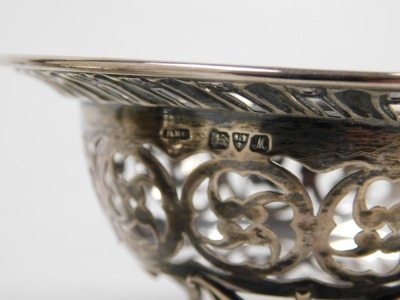 A George V silver sweetmeat dish, with pierced floral and foliate decoration, raised on three hoof feet, Chester 1912, and a further sweet meat dish, raised on three scroll feet, Sheffield 1927, 3.18oz. - 3