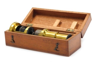 A Victorian brass cased student's microscope, mahogany cased, 15.5cm high.