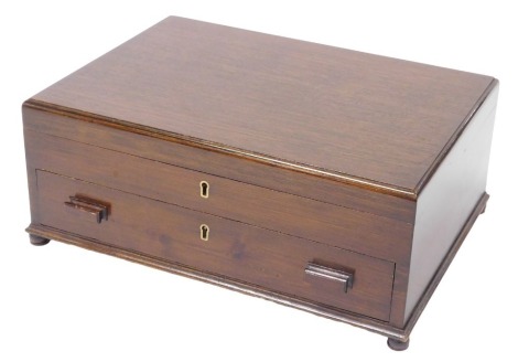 An early 20thC oak cutlery canteen box, with a hinged lid above a fitted interior, and further fitted frieze drawer, raised on bun feet, 42cm wide, 30.5cm deep.