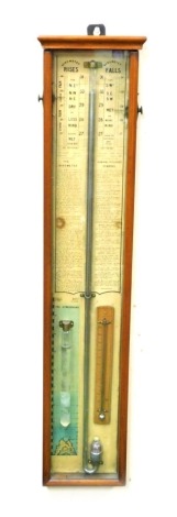 A late Victorian mahogany cased Admiral Fitzroy's barometer, with thermometer and atmosphere measure, on a detailed backing sheet, with scales of rises and falls, details of the barometer and Admiral Fitzroy's remarks, 91cm high.