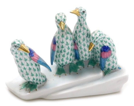 A Herend porcelain figure group of penguins, green scale ground, raised on an iceflow base, printed, impressed and painted marks, 15.5cm wide.