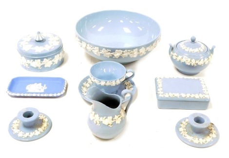 A group of Wedgwood Embossed Queens ware pottery, including a fruit bowl, sucrier and cream jug, and a pair of chamber sticks. (a quantity)