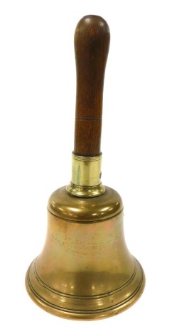 A brass bell, with a turned wooden handle, 29.5cm high.