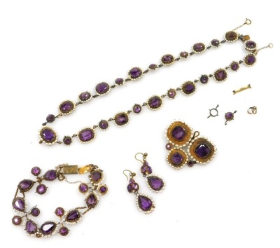 A late 19thC parure of amethyst set jewellery, in yellow metal, each with a faux pearl surround, comprising a necklace with detachable clip pendant, bracelet and pair of earrings. (AF)