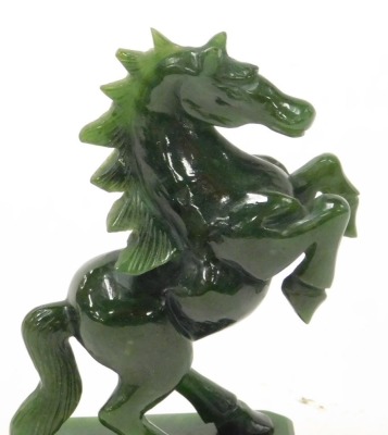 A jade figure of a prancing horse, raised on a canted rectangular base, 13cm high. - 2