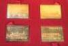 A set four gold-plated sterling silver railway anniversary stamp replicas