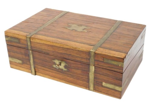 A Victorian style rosewood and brass bound writing slope, with brass strap work and escutcheons, the hinged lid opening to reveal a fitted interior, with key, 13cm high, 36cm wide, 22cm deep.