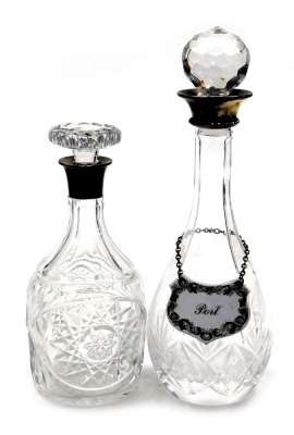 An Elizabeth II cut glass and silver mounted decanter, and stopper, Birmingham 1955, and a further decanter and stopper, with silver mount, and an enamel Port label, Birmingham 1984. (2)