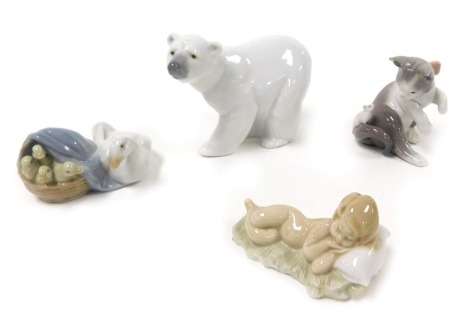 Four Lladro porcelain figures, comprising a kitten with mouse, polar bear, Moses asleep on a pillow, and a duck with ducklings.