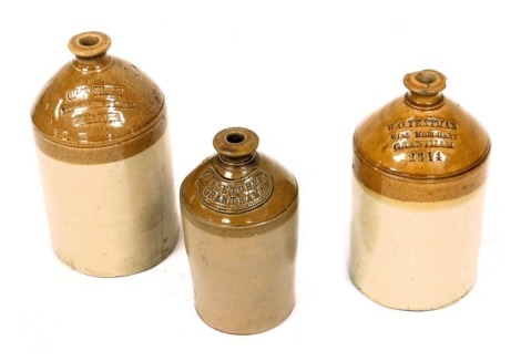 A 19thC two tone stoneware flagon, for F Fletcher, Grantham, number 434951, a wine jar for W O Yeatman wine merchant, Grantham, 2614, and another for Charles Smith, Bristol Arms hotel, Sleaford. (3)