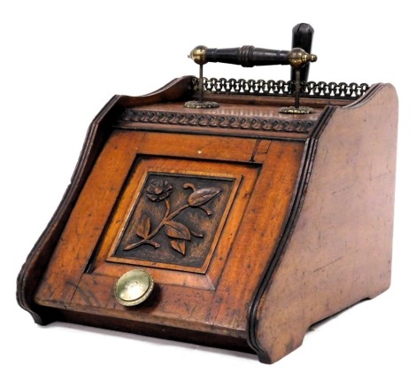 A Victorian mahogany coal box, with a turned wooden and brass handle, the hinged flap carved with a floral panel, with lead liner, 30.5cm high, 34cm wide, 47cm deep.