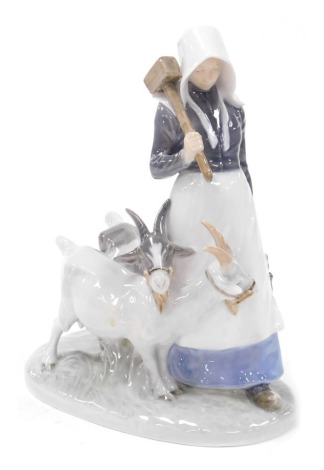 A Royal Copenhagen porcelain figure group of a country woman with goats, number 694, printed and painted marks.