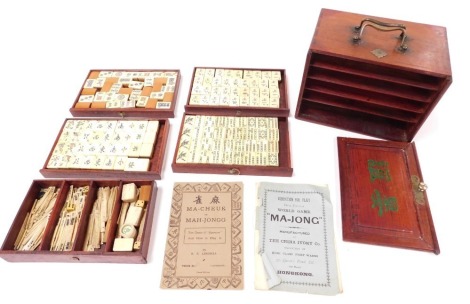 An early 20thC Chinese bone and bamboo Mahjong set, in a five graduated drawer cabinet, with lift up front, brass carrying handles, 24cm wide.