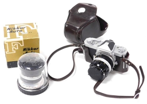 A Nikon Nikkormat camera, with a 35mm lens, cased, and an auto 50mm lens, boxed.