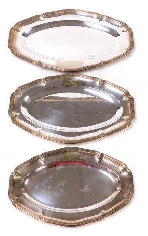 Three graduated silver plated piecrust platters, the largest 45.5cm wide.