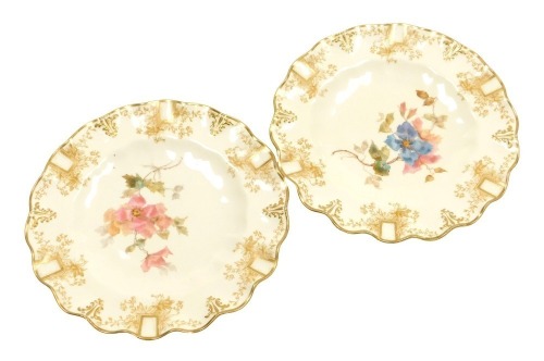 A pair of late 19thC Royal Crown Derby porcelain cabinet plates, painted with flowers, within a floral and gilt heightened border, printed and impressed marks, 22cm wide.