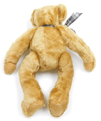 A Teddy bear, with jointed arms and legs, and black button eyes, 35cm high. - 2