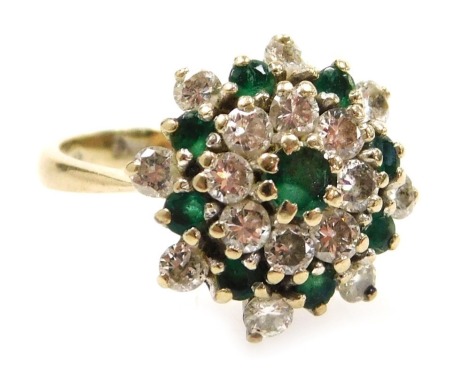 An 18ct gold diamond and emerald ring, in a flower head setting, diamonds approximately 1ct, size N, 5.5g.