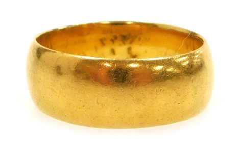 A 22ct gold wedding band, size J, 5.2g.