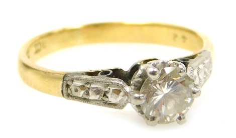 A diamond solitaire ring, set in white and yellow metal, high claw set, stamped 18ct and plat, approximately 0.5ct, size J/K, 2.3g.