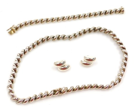 A suite of silver jewellery, in a spiral twist design, comprising a necklace and bracelet, each on a snap clasp, and a pair of earrings, in a Penelope Red of Reigate box, 100.6g.