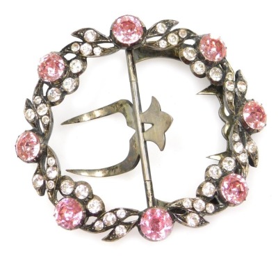 An early 20thC pink and white paste set buckle, in white metal, 7cm wide.