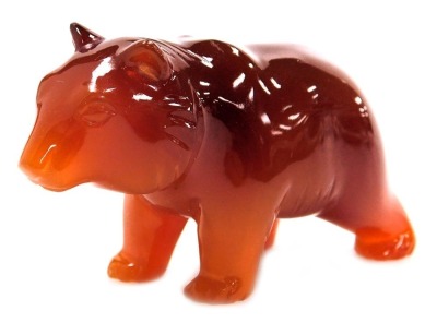 A red agate carving of a polar bear, 7cm wide.