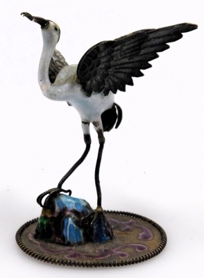 An early 20thC silver and enamel figure of a stork, modelled perched on a rock, 7cm high, continental white metal and champleve enamel cylindrical pot and cover, raised on three ball feet, and a Russian lacquer box and cover, painted with a winter landsca - 4