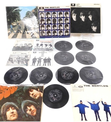 The Beatles LPs, comprising Rubber Soul, Help!, With the Beatles, A Hard Day's Night, and Abbey Road, together with 45rpm singles, four with sleeves, comprising The Beatles third Christmas record, the official Beatles fan club, and another Beatles Christm