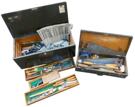 An ebonised carpenter's tool chest, the hinged lid opening to reveal assorted tools, 80cm wide, and a further chest enclosing tools, 71cm wide.