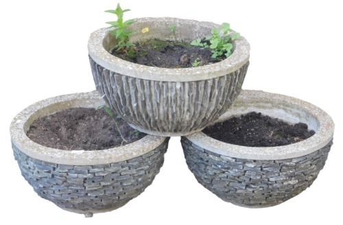 Three concrete circular planters, with textured sides, 27cm high, 51cm wide.