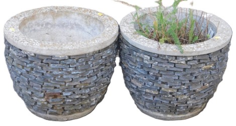 Two concrete circular planters, with textured sides, 32cm high, 40cm wide.