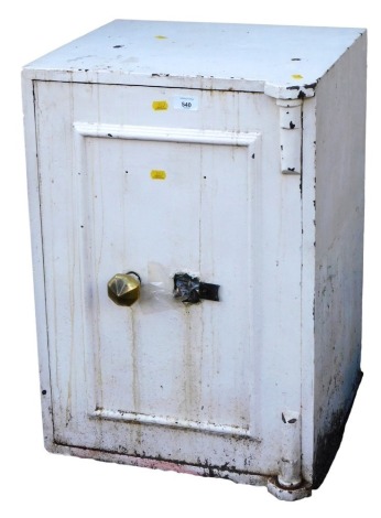 A cream painted cast iron safe, 66cm high, 46cm wide, 44cm deep.