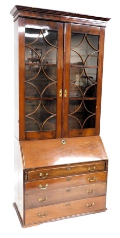 A George III mahogany bureau bookcase, the associated top with two astragal glazed doors, the base with a fall and four long drawers with brass drop handles, on bracket feet, 151cm high approx, 113cm wide. (AF)