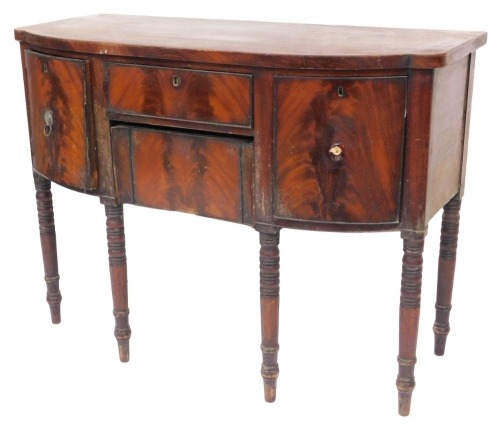 A George III mahogany bowfront sideboard, with cellaret drawer, central frieze drawer and concealed drawer, with ebonised ring turned legs, 92cm high, 122cm wide, 54cm deep.