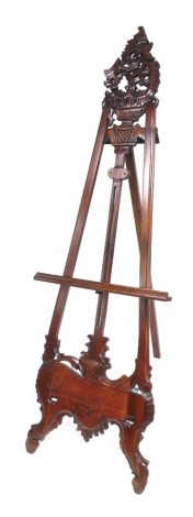 An 18thC style mahogany artist's easel, with foliate carving, 215cm high, 69cm wide.