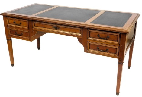 A French style cherrywood desk, the rectangular top with three black and gilt inserts above an arrangement of five drawers, on square tapering legs, 78cm high, 160cm wide, 75cm deep.