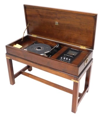 A mahogany cased Dynatron radiogram, with a Dynotron radio and stereophonic tuner amplifier SRX 29C, and a Garrard SP25 MKIV turntable, the box casing raised on square legs united by a H stretcher.